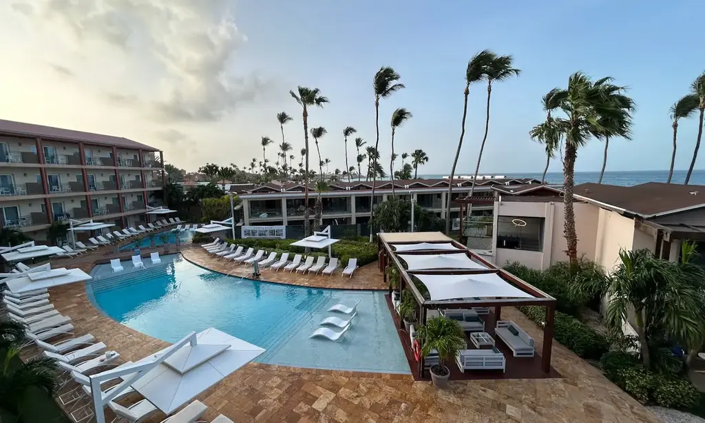 Photo of resort hotel and pool with palm trees