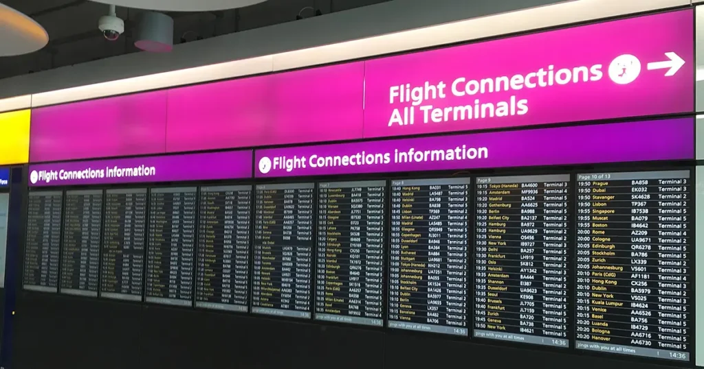 Flight Connections sign in airport terminal with flight information screens