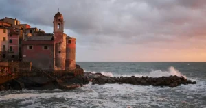 An off the beaten path Italy hidden gem, Tellaro features colorful cliffside buildings overlooking small boats along its rocky coast.